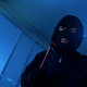 Thief breaking and entering with flashlight
